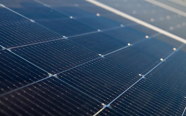 Close-up of solar panels installed on a solar farm, generating renewable energy from sunlight.